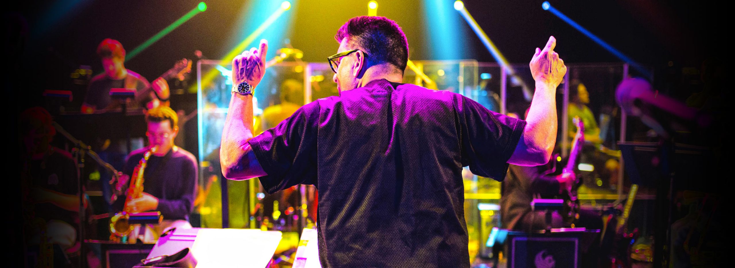 Director Jeff Rupert conducts the band during onstage rehearsal.